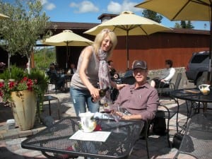 woman pouring wine for man on outdoor patio