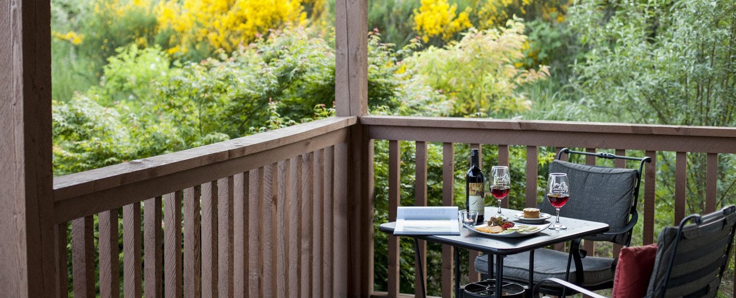 Wine and cheese plate on the porch of the Mt. Hood Cabin at Carson Ridge Luxury Cabins in the Columbia River Gorge.