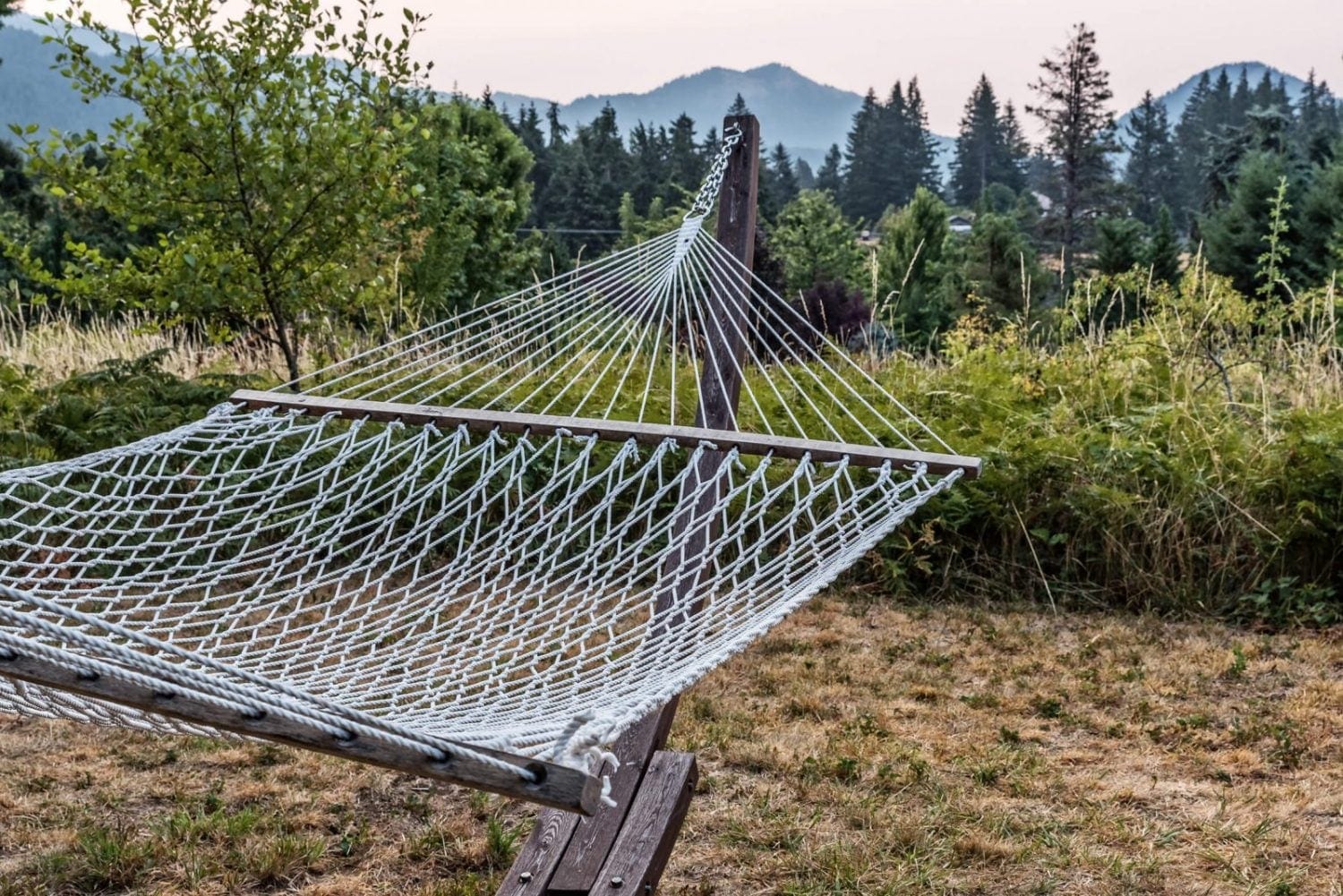 A hammock looks toward the Gorge from the grounds at Carson Ridge Luxury Cabins in Carson, Washington.