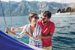 Loving couple spending a happy time on a boat.