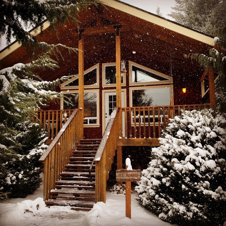 Snowflakes fall in front of the Mt. Adams cabin at Carson Ridge Luxury Cabins in Washington State.