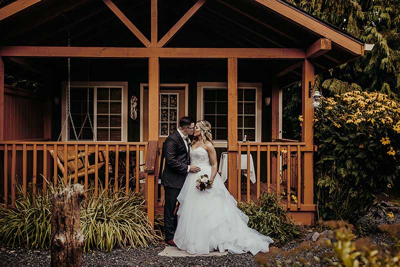 A couple in front of our cabins, a great place to plan your elopement in Washington State
