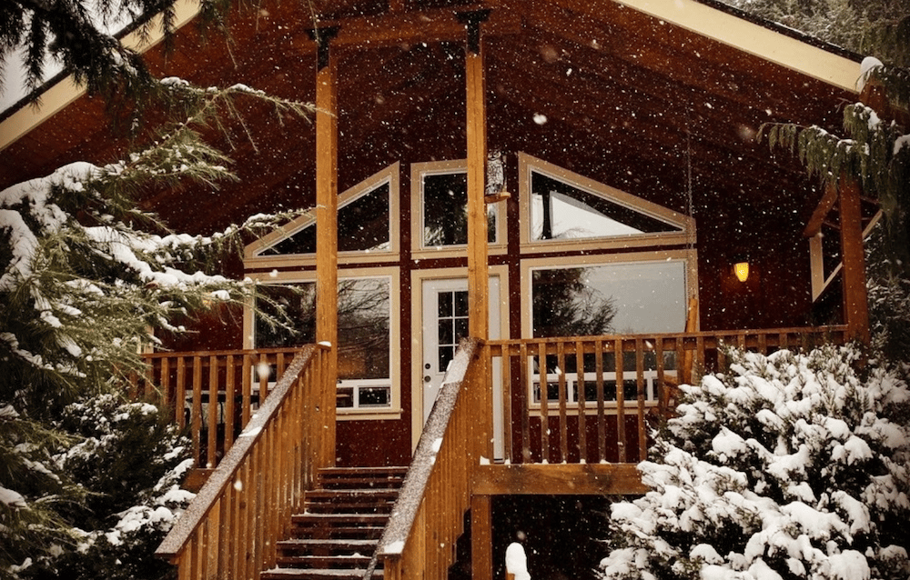 One of our beautiful cabins in Washington surrounded by snow - a great place to retreat after dinner at one of the best Hood River restaurants