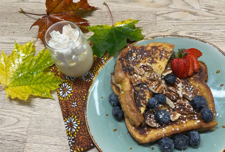 A breakfast of hot Eggnog French Toast sits on the table, topped with fresh blueberries and chopped walnuts at Carson Ridge Luxury in Carson Washington near Hood River, Oregon.
