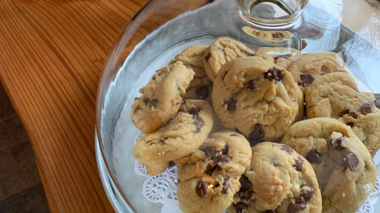 A plate of freshly baked chocolate cookies sit under a glass cover awaiting guests at Carson Ridge Luxury Cabins in Washington State.