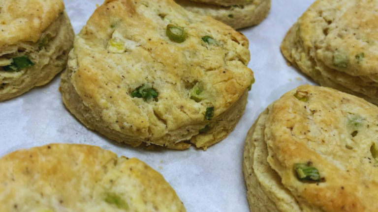 Black pepper, green onion and sour cream biscuits sit cooling on a baking sheet ready for breakfast at Carson Ridge Luxury Cabins in Washington State.