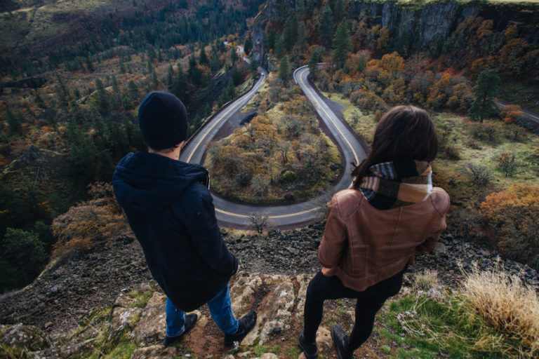 A couple looking at Horsebend in the road in the Columbia River Gorge - one of the many fun anniversary activities to enjoy when you take advantage of our anniversary getaway package at our luxury cabins in Washington