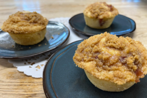 Peach muffins with streusel topping sit on plates ready for breakfast at Carson Ridge Luxury Cabins in Skamania County, Washington State.