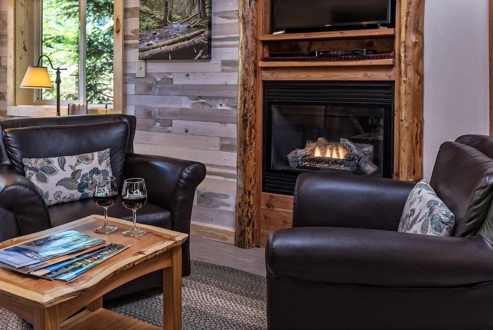 One of our Luxury Cabin fireplaces with glasses of wine - the perfect spot for an elopement and honeymoon in Washington State