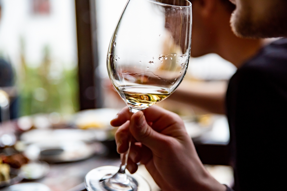 Visit the Hiyu Wine Farm 5 Man enjoying a winter wine tasting at Hiyu Wine Farm, one of the best wineries in Hood River